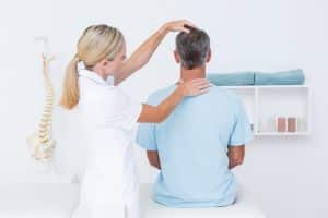 Chiropractor using one of the types of chiropractic adjustment to help a patient